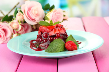 Tasty jelly dessert with fresh berries, on bright background