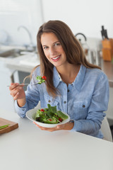 Attractive woman eating a salad