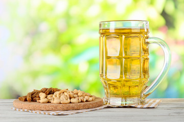 Beer in glass crunches, and nuts