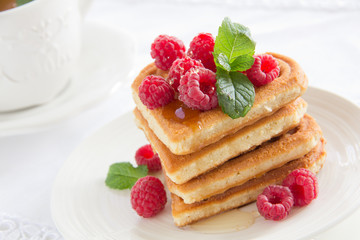 Waffles with raspberry, honey and chocolate.