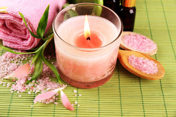 Obraz na płótnie Canvas Beautiful spa setting with pink candle on bamboo mat