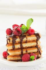 Waffles with raspberry, honey and chocolate.