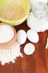 Ingredients for dough on wooden table close-up