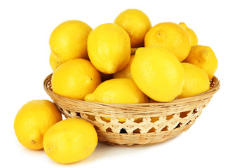 Ripe lemons in wicker basket isolated on white
