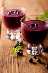 Glass of fresh blueberry smoothie with blueberries