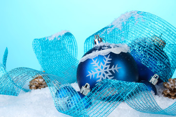beautiful blue Christmas balls and cones in snow