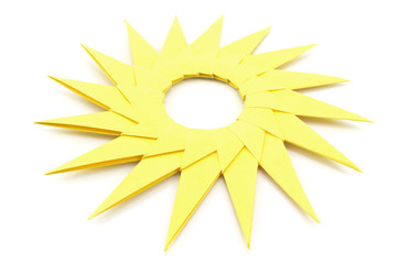 Origami  yellow paper sun on a white