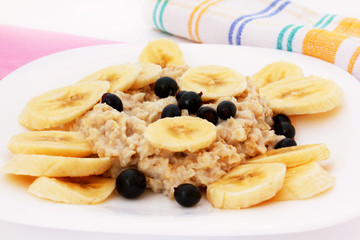 oatmeal with bananas and black currant close up