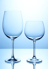 Empty wine glasses arranged on blue background