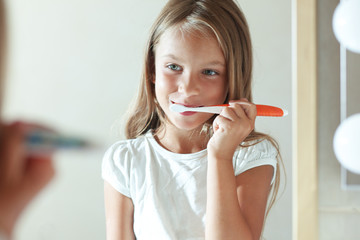 Girl brushes teeth