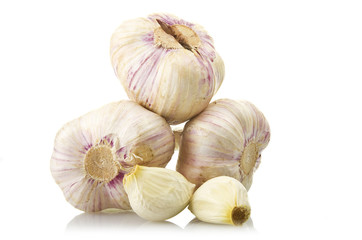 fresh garlic and two garlic cloves on the white