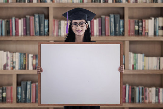 Graduate woman with blank board