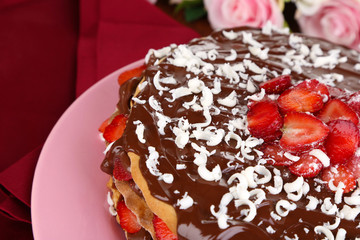 Chocolate cake with strawberry on wooden table close-up