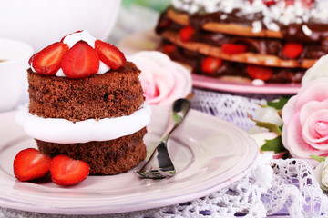 Chocolate cake with strawberry on wooden table close-up