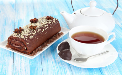 Sweet roll with cup of tea on table close-up