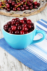 Sweet cherry in cup on table close-up