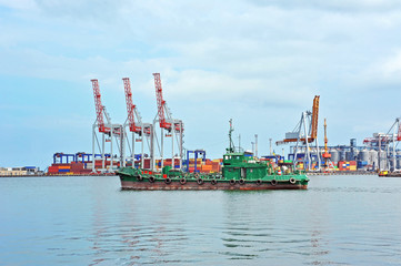 Container stack and ship under crane bridge