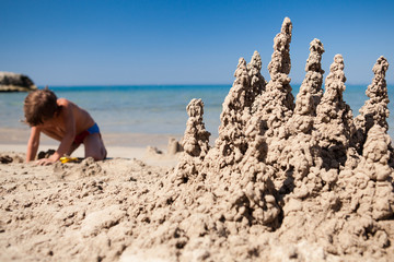 Boy making sand castle on beach