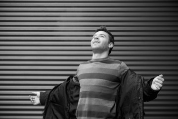 Happy to be free. Happy handsome men standing with his hands out