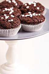Vegan chocolate muffins on a cake stand