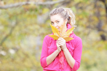 young happy woman with colorful umbrella in autumn park