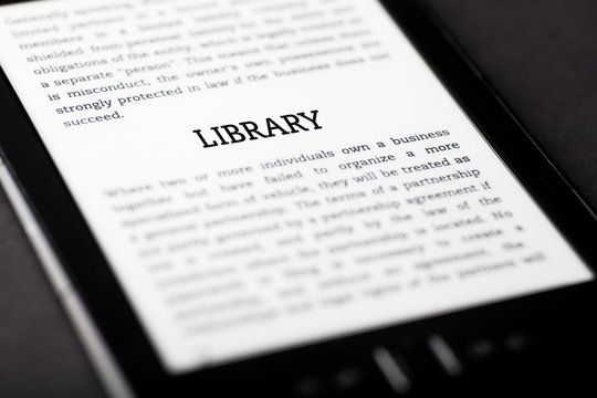 Library on tablet touchpad, ebook concept