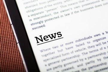 Obraz premium News on tablet screen, ebook concept