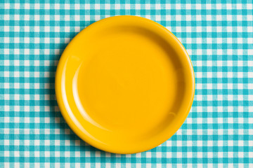 empty plate on checkered tablecloth
