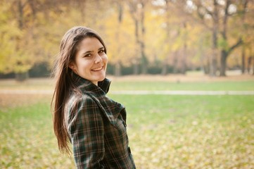 Outdoor autumn portrait of young woman