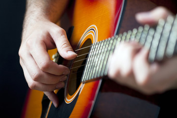 Close up on  hands playing on guitar