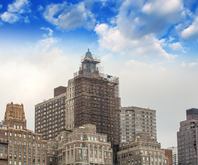 Fototapeta na wymiar Group of old skyscrapers in New York against beautiful sky