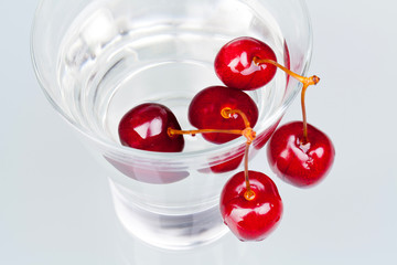 glass with water and cherries