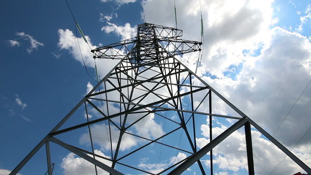 tall electric masts against cloudy sky - timelapse