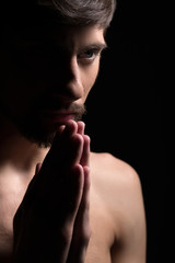 Young man praying. Portrait of a young man praying