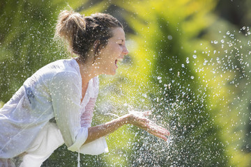 Happy girl under drops