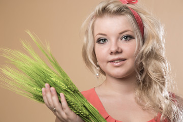 Naklejka premium Portrait of the girl with ears of barley