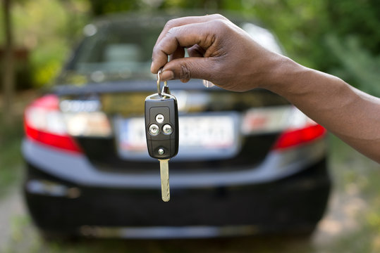 Man Holding Car Keys