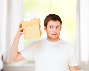 man in white t-shirt with gift box