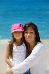 Mother and daughter by the ocean