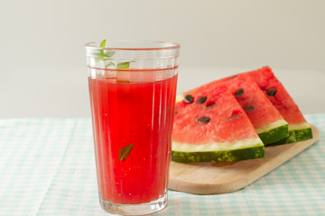 Glass of watermelon smoothie isolated on white.