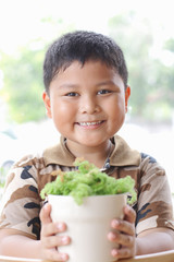 The boy is happy. With small trees.