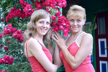 Two young women with red roses