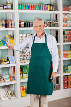 Male Store Owner Gesturing In Supermarket