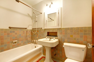 Bathroom with old antique fixtures and white tub.