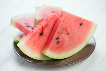Horizontal shot of a plate with watermelon slices, close-up