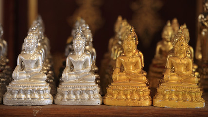 Many gold and silver small Buddha statues