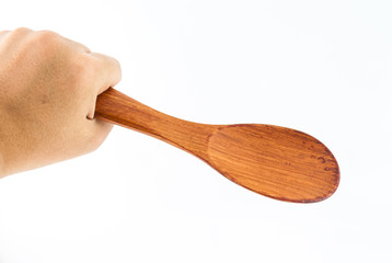 Wooden Spoon in hand Isolated on a white background