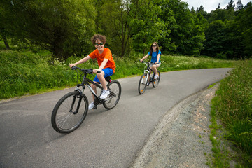 Fototapeta premium Healthy lifestyle - teenage girl and boy biking
