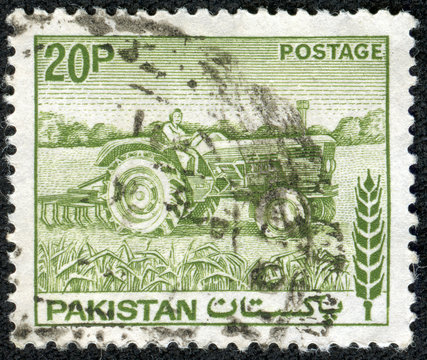stamp printed in Pakistan shows woman tractor driver