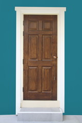brown wood door with green wall
